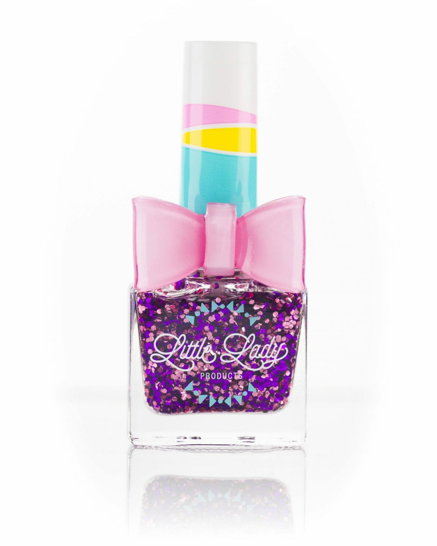 Mermaid Dreams nail polish bottle with pink and purple sparkles, designed for kids, featuring a playful bow ring accessory.